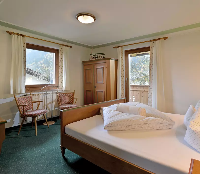 Schlafzimmer mit Doppelbett und Balkon im Appartement Jakob - Landhaus Kumbichl