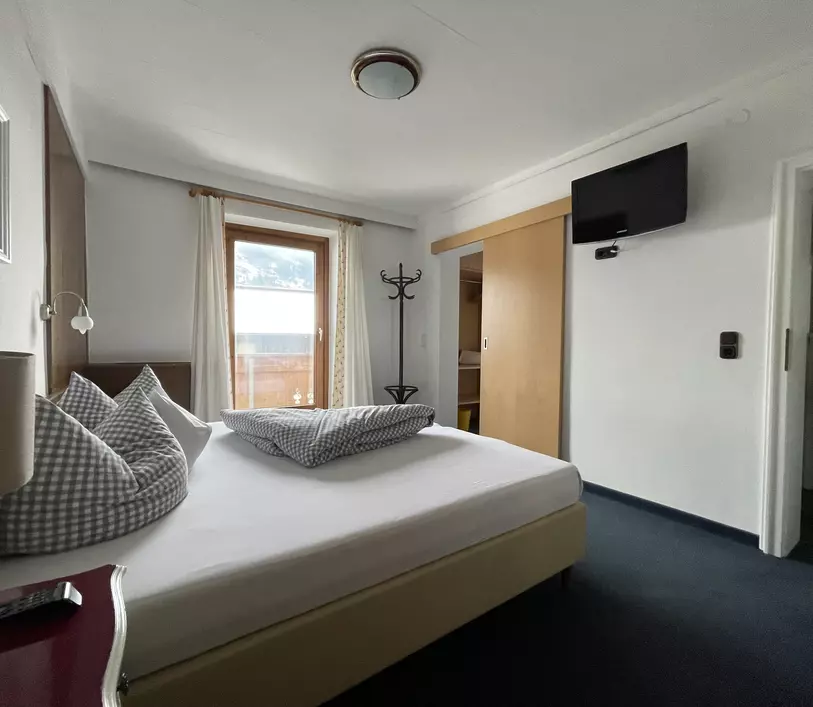 Schlafzimmer mit Doppelbett und Balkon im Appartement Michael - Landhaus Kumbichl